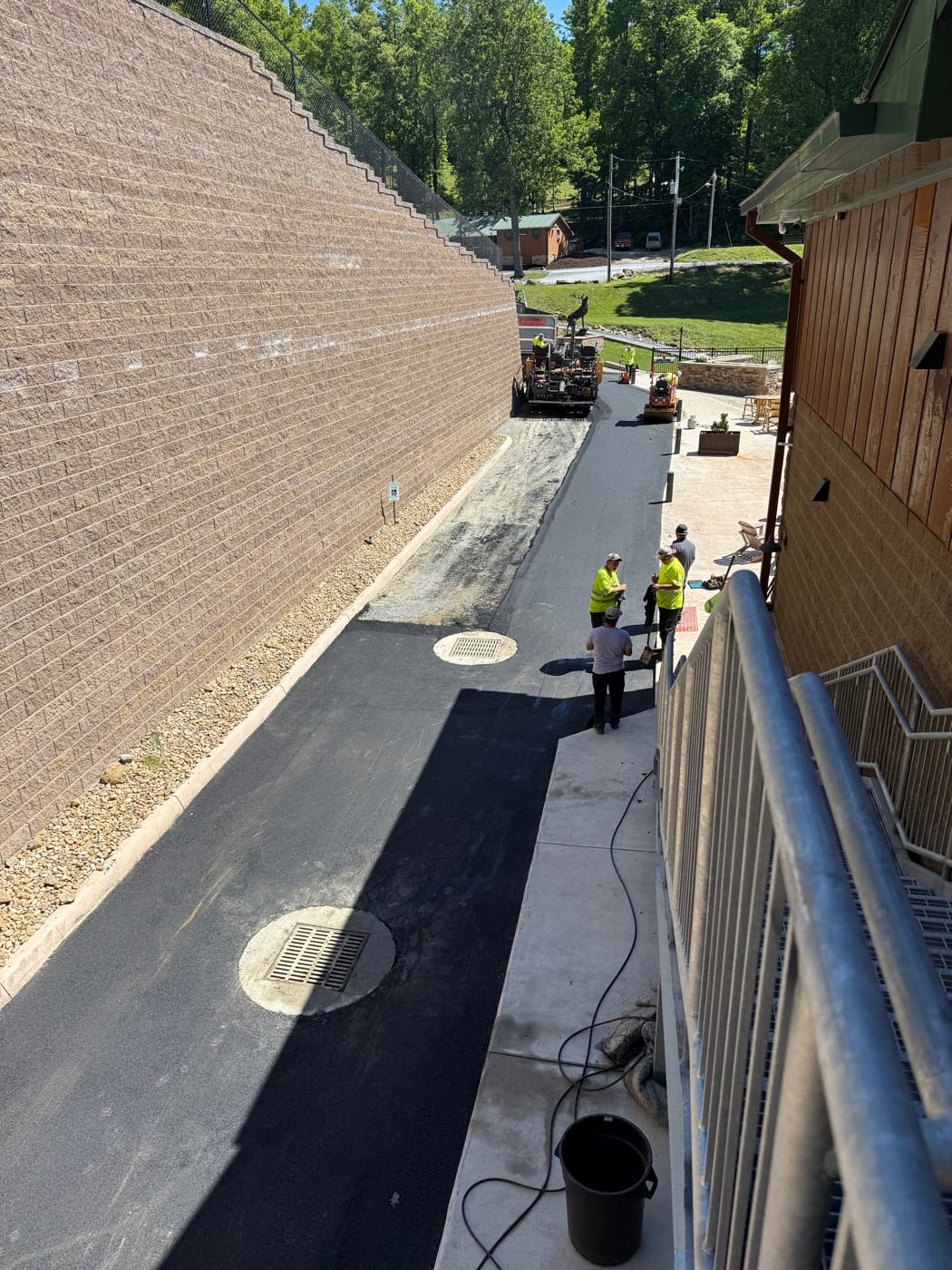 Road crew paving the access lane beside the lodge